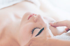 Relaxed woman lying on spa bed for facial and head massage spa treatment by massage therap